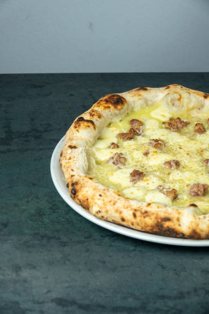 istock Neapolitan pizza with sausage and potatoes at the pizzeria table 1703845710
