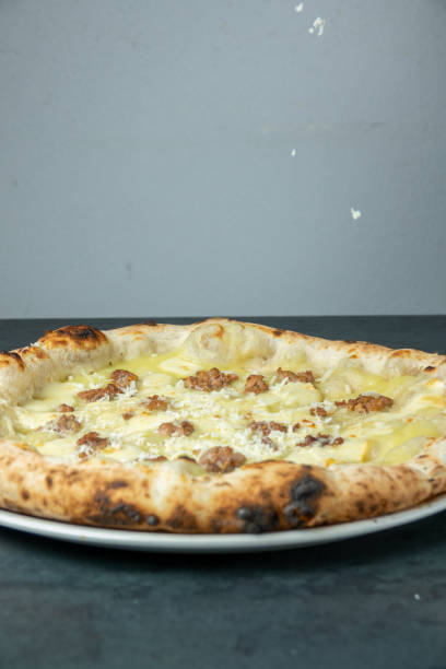 istock Neapolitan pizza with sausage and potatoes at the pizzeria table 1703845717