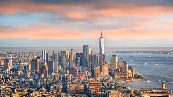 Lower Manhattan skyline at sunset with Freedom Tower standing tall above the skyline