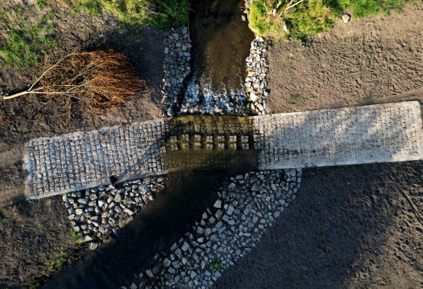 The dirt road leads across a stream that crosses river and continues when the flood road is impassable. restoration of watercourses and relocation upright drainage of fields into meandering The dirt road leads across a stream that crosses river and continues when the flood road is impassable. restoration of watercourses and relocation upright drainage of fields into meandering , river ford, wade impassable limit stock pictures, royalty-free photos & images