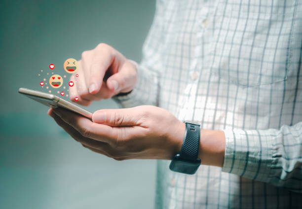 istock Man using smart phone with social media,with notification icons of like, message, email, comment and star above smartphone screen,social network 1703861087