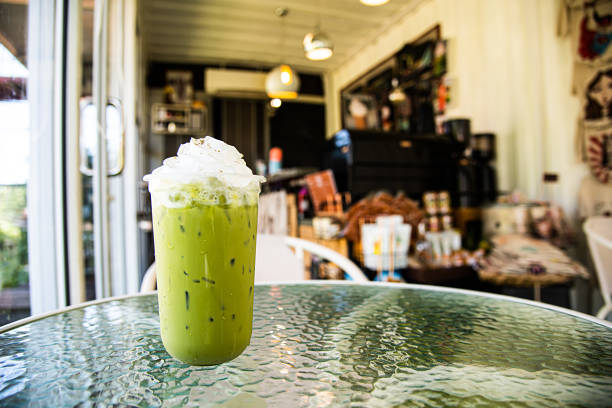 Green tea smoothies in glass on glass table
