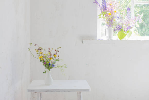 istock flowers in white vase in white vintage interior 1703884341