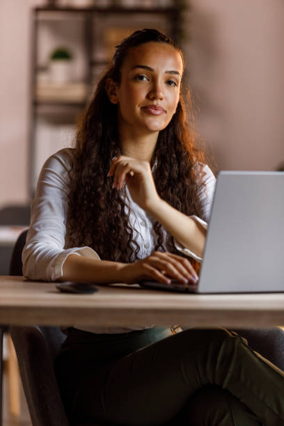 istock Diligent young woman using laptop at her desk 1703892562
