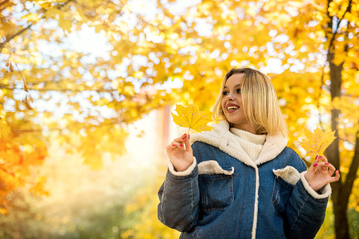 happy cheerful young woman walking in autumn forest, park. Freedom lifestyle