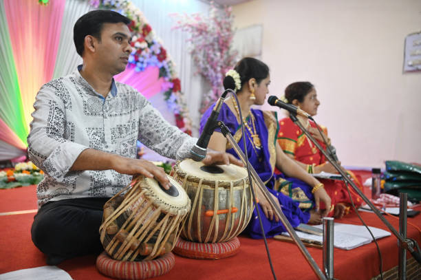 In this captivating stage performance, harmony in tradition, two exceptionally talented women, adorned in the elegance of classical attire, join forces to sing a soul-stirring classical song with a skilled talented Tabla Musician