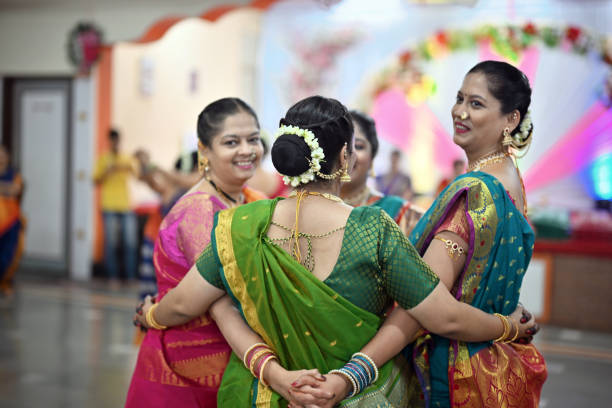 istock Group of women gracefully dancing during  a traditional Mangala Gaur celebration 1703908367