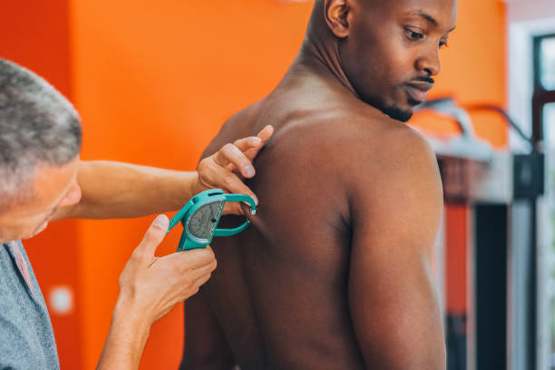 istock Coach measuring client's body fat with caliper 1703911677