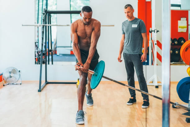 istock Conditioning training with personal trainer in gym 1703913366
