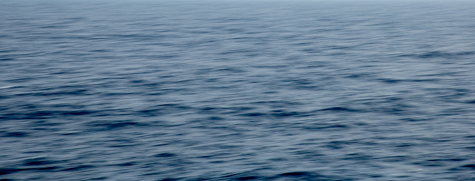 Panoramic seascape. Nature backround. Ocean only. Long exposure moving blury water.