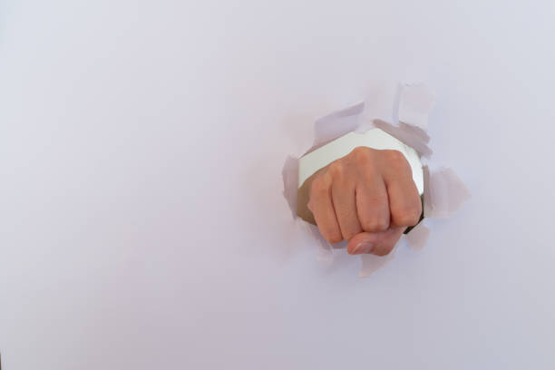 istock hand tearing paper 1703929195