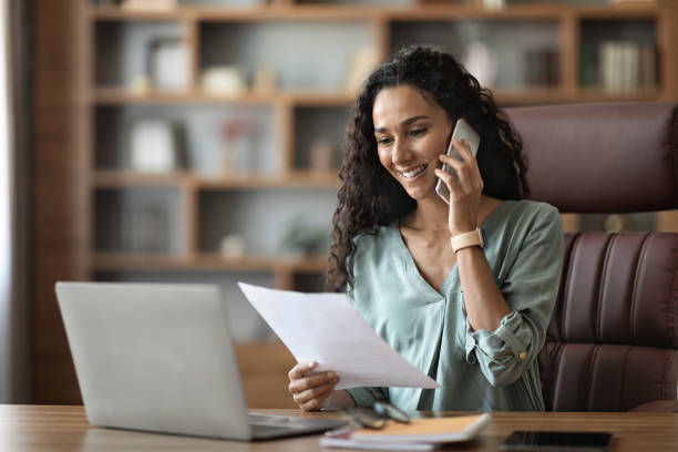 istock Happy young woman entrepreneur having phone conversation 1703935346