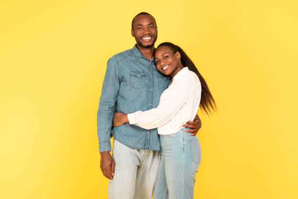 istock Happy African American Couple Hugging Posing On Yellow Background 1703935901