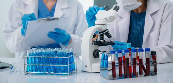 Medical team having a meeting with doctors. Young scientists conducting research investigations in a medical laboratory, a researcher.