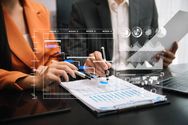 istock Business team hand Project manager working and update tasks and Gantt chart scheduling virtual diagram.with smart phone, tablet and laptop in office. 1703937097