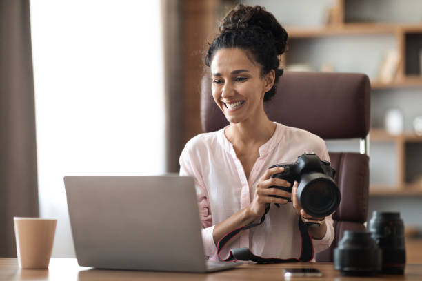 istock Happy creative millennail woman photographer working at office studio 1703937403