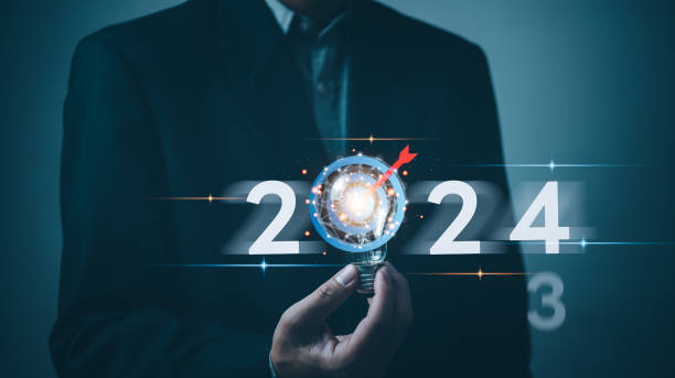 istock 2024 calendar business planning target and strategy growth success innovation. Creative thinking idea marketing finance investment concept.Hand holding lightbulb. 1703940104