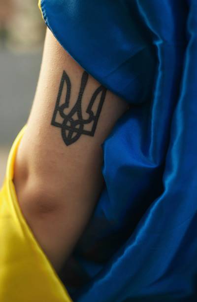 istock Trident tattoo on the arm 1703945795