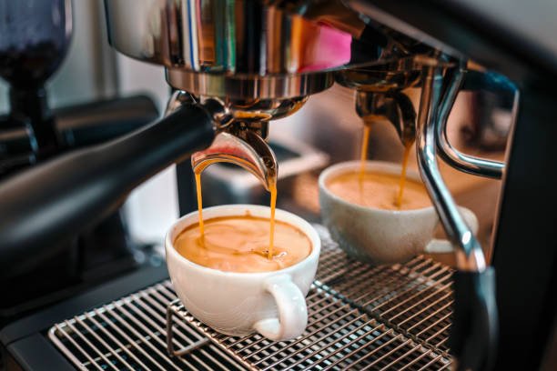 istock Coffee extraction from the coffee machine with a portafilter pouring coffee into a cup,Espresso pouring from the coffee machine at coffee shop 1703955118