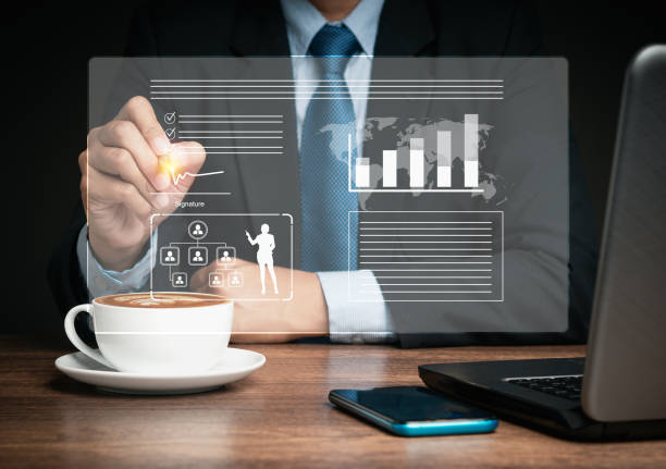 istock Businessman uses a pen to sign electronic documents on a virtual screen while sitting at the table 1703966034