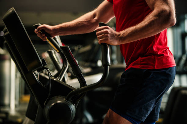istock Midsection of male athlete doing cardio on elliptical machine 1703973109