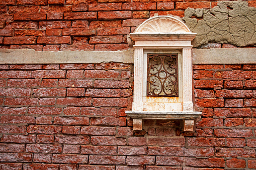 old window in a red brick wall