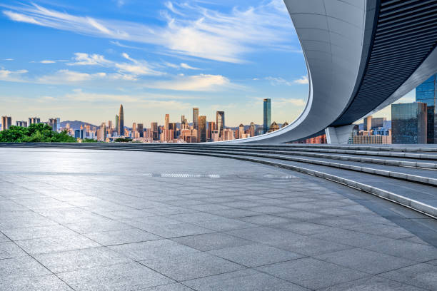 istock Empty square floor and city skyline at sunset 1703980281