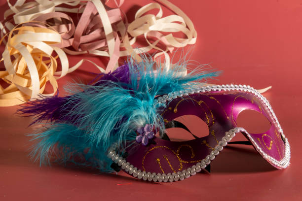 istock Venetian carnival mask with feathers, and typical elements in the background 1703991204