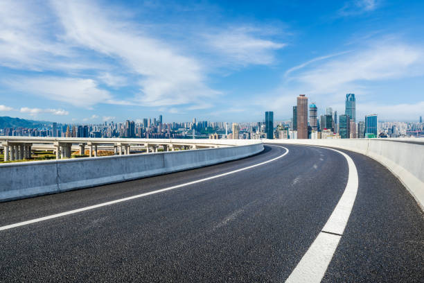 istock Asphalt road and city skyline 1703992263