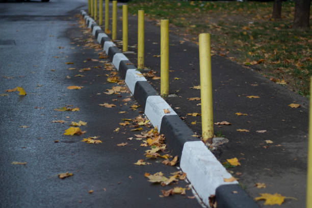 istock Yellow bollards along the pedestrian zone. Restricting parking on the walkway. Painted border. 1704012242