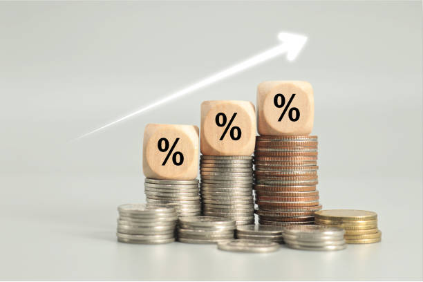 istock graph arrow and percent icon on wooden cube. inflation concept 1704042488