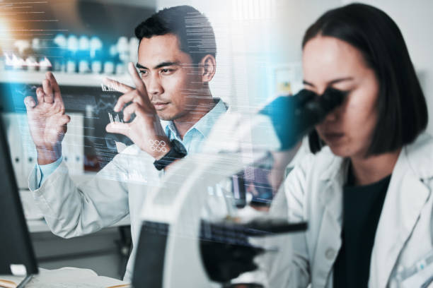 istock Science, research and people with hologram, microscope and futuristic with chemistry, data analytics and teamwork. Holographic, staff and coworkers with cooperation, medical and healthcare in a lab 1704044132