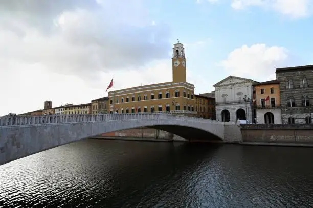 Mezzo Bridge crossing the Arno river in the city of Pisa with the Pretorio Palace in the background