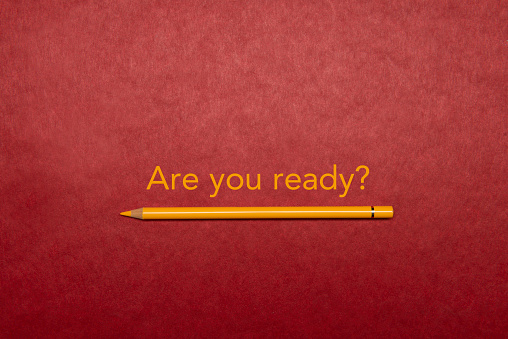 Yellow pencil on red background.