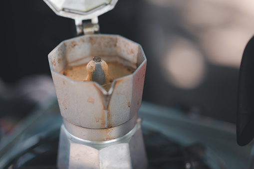 Barista making coffee with moka pot machine  in coffee shop,Coffee machine making coffee