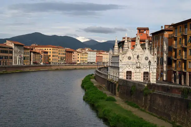 Bank of the Arno of the city of Pisa with the church of Santa Maria della Spina and Monte Pisano in the background