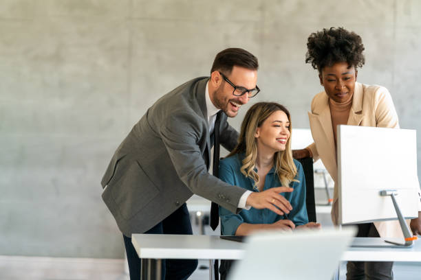 istock Happy businesspeople laughing while collaborating on a new project in an office. 1704068268
