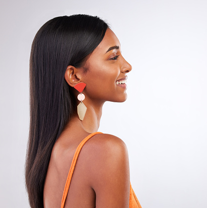 Beauty, fashion and profile of Indian woman in studio with makeup, cosmetics and glamour in accessories. Smile, aesthetic and face of person on white background with glow, wellness and confidence