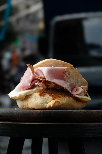 Sandwich with cooked ham, mozzarella and tomato cream