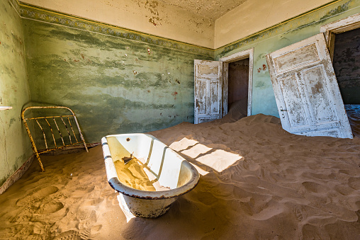 Deserted homes in Kolmanskop ghost town near Luderitz in Namibia, the site of an abandoned diamond mine