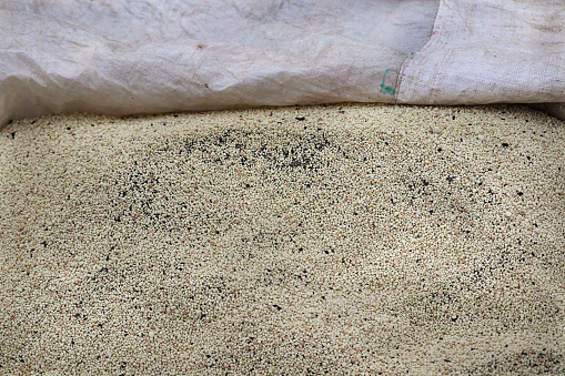 Pellets of ammonium nitrate flat lay with. Mineral fertilizer. granular mineral fertilizer, closeup top view. with black Mineral plant food dressing