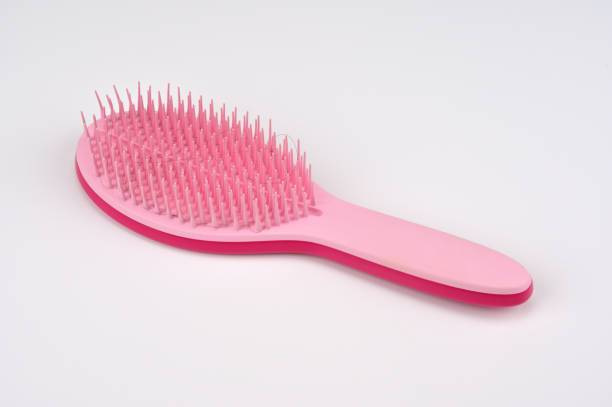 istock Hair gets tangled in the pink brush 1704157502