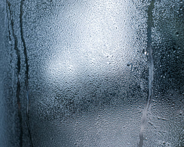 istock wet glass, gray background, Drops on a glass surface, grey gradient 1704157546