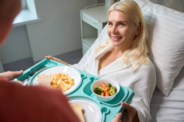 istock Nurse is taking care of a patient on bed rest 1704164516