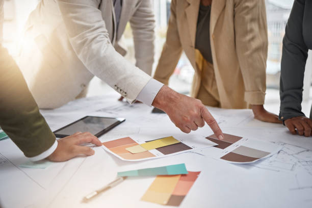 istock Creativity, color palette and team in a meeting for an interior design project in office boardroom. Industry, collaboration and group of designers in discussion working with blueprints in workplace. 1704167531