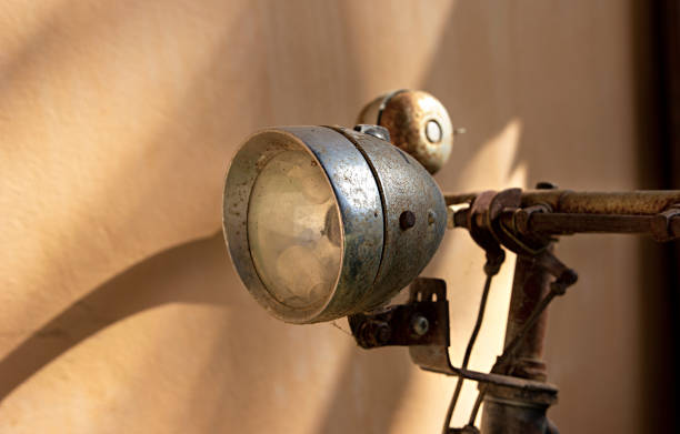 istock Close up of old vintage bicycle headlight chrome on wall background 1704168663