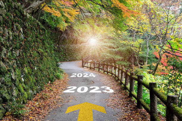 2023 to 2024 new year with arrow on beautiful walkway stock photo