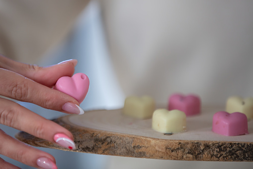 A woman is serving a heart shaped chocolate at cafe.