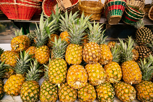 Close-up on pineapples in the produce aisle at the supermarket