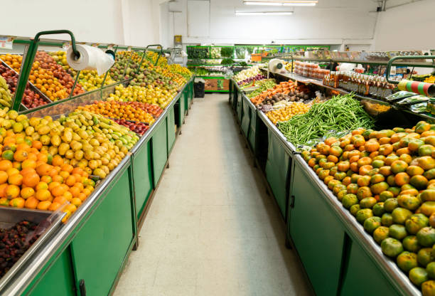 Fruits and vegetables in the produce aisle at the supermarket - food and vegetables concepts